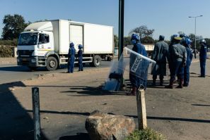 Police ask for travel documents at a road block in Mbare, a township in the suburbs of Harare