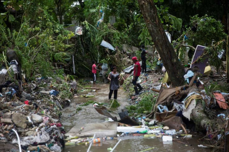 Locals try to rescue their belonging after the overflow of the Magua river caused by heavy rains caused during Isaias storm in the city of Hato Mayor, northwest of Santo Domingo, Dominican Republic, on July 31, 2020