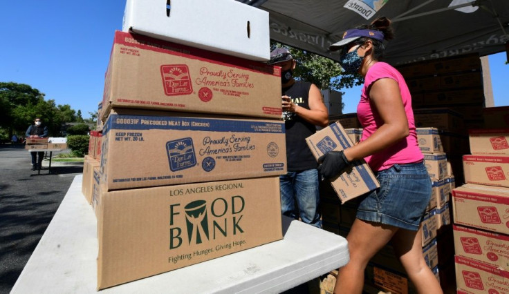 Volunteers prepare to load vehicles with boxes of food at a food bank in Duarte, California on July 8, 2020
