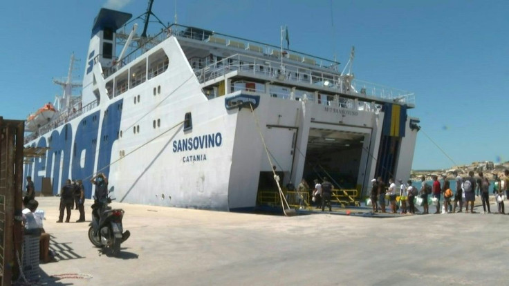 Migrants board a tourist ferry from Lampedusa to Porto Empedocle, Sicily