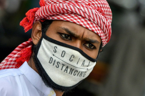 A Muslim wearing a face mask comes out of Masjid-e-Eidgah Bilal after offering prayers during the Eid al-Adha, the feast of sacrifice, in Bangalore on August 1, 2020.