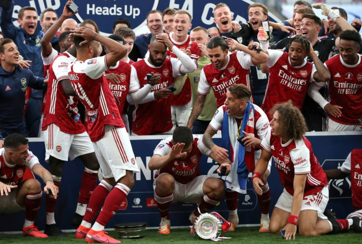 Pierre-Emerick Aubameyang (left) reacts after dropping the FA Cup