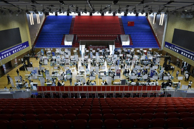Hundreds of young Chinese stream in and out of a job fair on a recent weekend in Zhengzhou