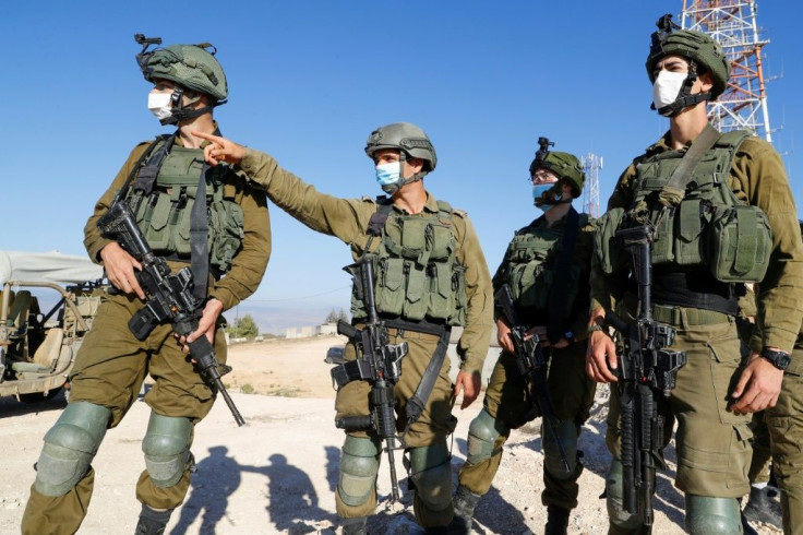 Israeli soldiers monitor the country's border with Lebanon near the northern town of Metula on July 14
