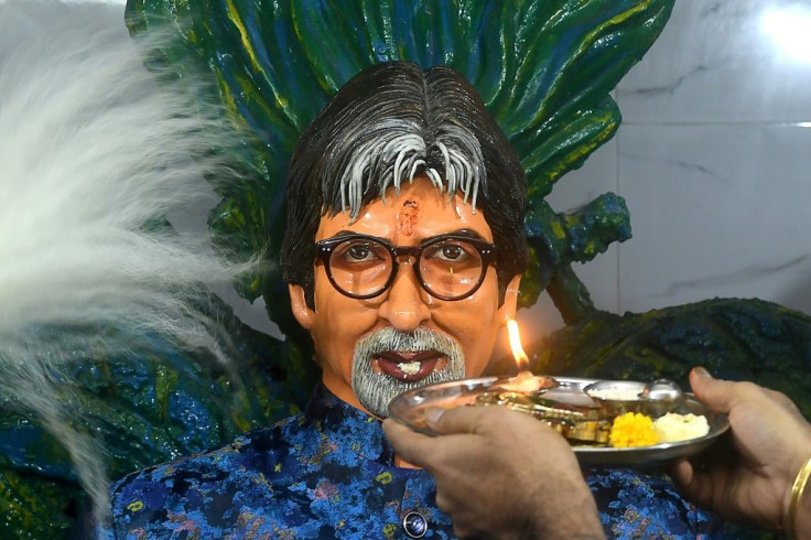 A fan makes an offering to a statue of  Bollywood actor Amitabh Bachchan at a temple named after him in Kolkata