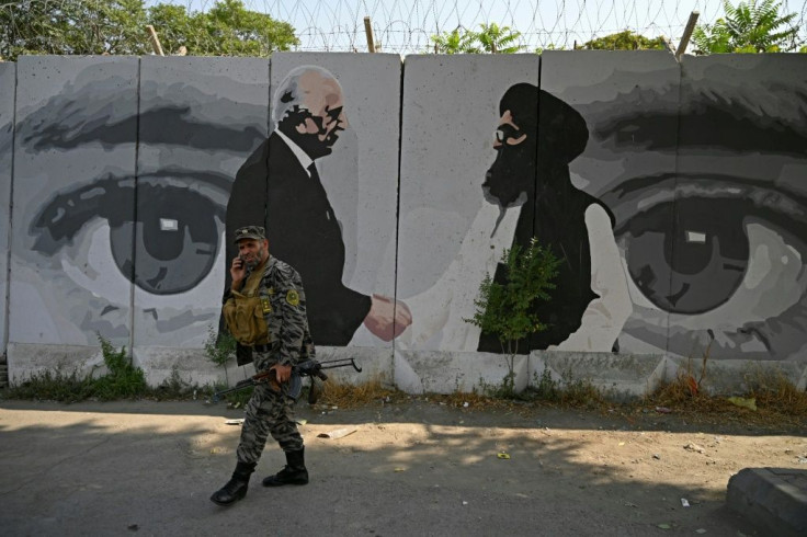 A mural depicts US special envoy Zalmay Khalilzad (L) and Taliban co-founder Mullah Abdul Ghani Baradar. Under the US-Taliban deal, 'intra-Afghan' talks were to start in March but hit delays amid political infighting in Kabul