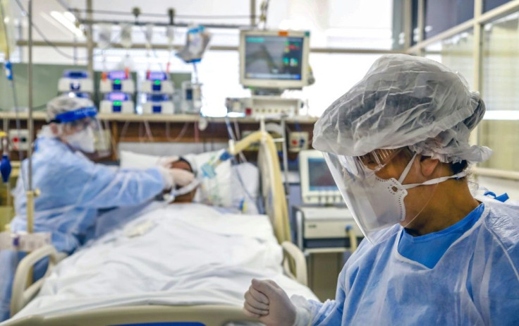 Doctors treat a patient infected with COVID-19, which has pushed the Brazilian health care system to the brink, at the Intensive Care Unit of the Hospital de Clinicas, in Porto Alegre, Brazil, on April 15, 2020