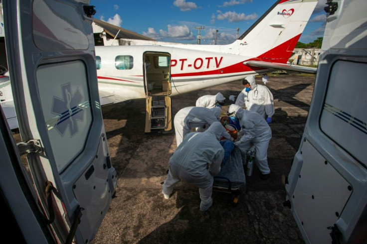 A Brazilian COVID-19 patient is moved on July 15, 2020 from a plane equipped as an ICU unit into an ambulance on the way to the Santarem Field Hospital, as the country's public health care system struggles to keep up with the coronavirus