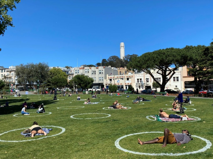 People practice social distancing at Washington square park in San Francisco