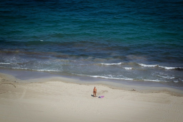 On Ibiza's beaches, travelling vendors hawking nightclub entries have given way to those selling ice cream and drinks