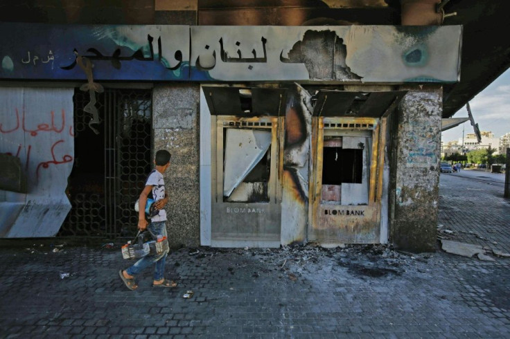 A burnt down branch of a Lebanese bank after it was vandalised by protesters in Lebanon's northern port city of Tripoli on June 12