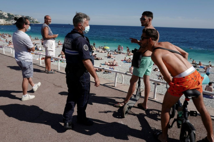 French police patrol to inform people that the wearing of a mask is mandatory in the French riviera city of Nice