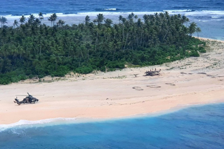 A photo taken by the Australian Defence Force shows an army ARH Tiger helicopter landing near the letters "SOS" on Pikelot Island
