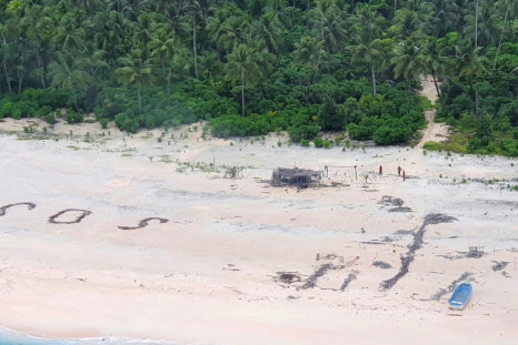 The Micronesian sailors were rescued after a search party spotted a giant SOS they had scrawled on the beach