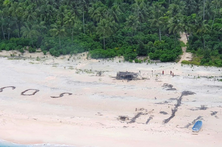 The Micronesian sailors were rescued after a search party spotted a giant SOS they had scrawled on the beach