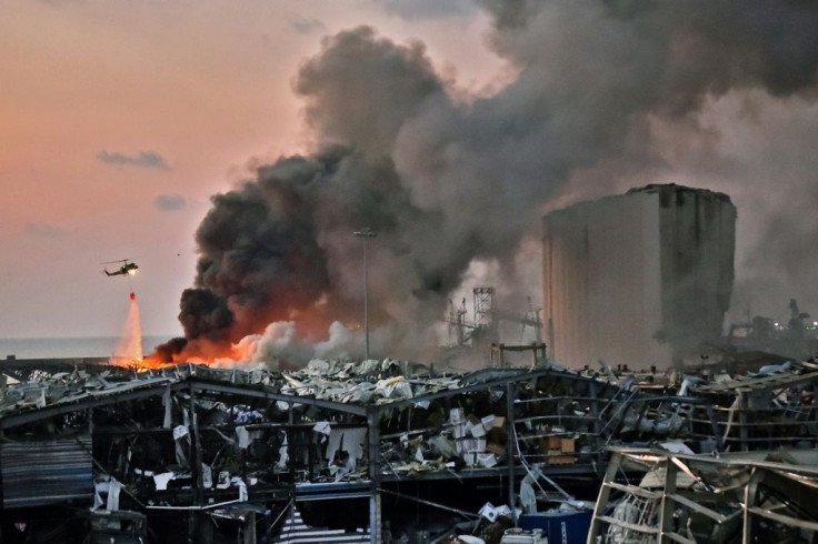 A helicopter puts out a fire at the scene of an explosion at the port of Lebanon's capital Beirut on August 4, 2020