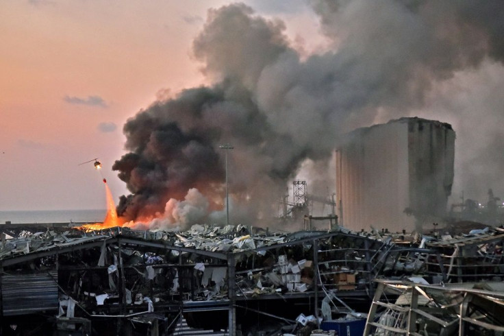 A helicopter pours water onto the fire at the port of Lebanon's capital Beirut