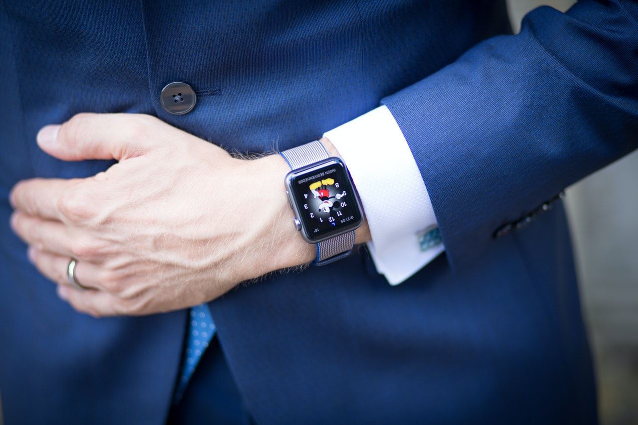 Watch around the wrist of a stylish business man. Busy businessman looking  at the time. Stress