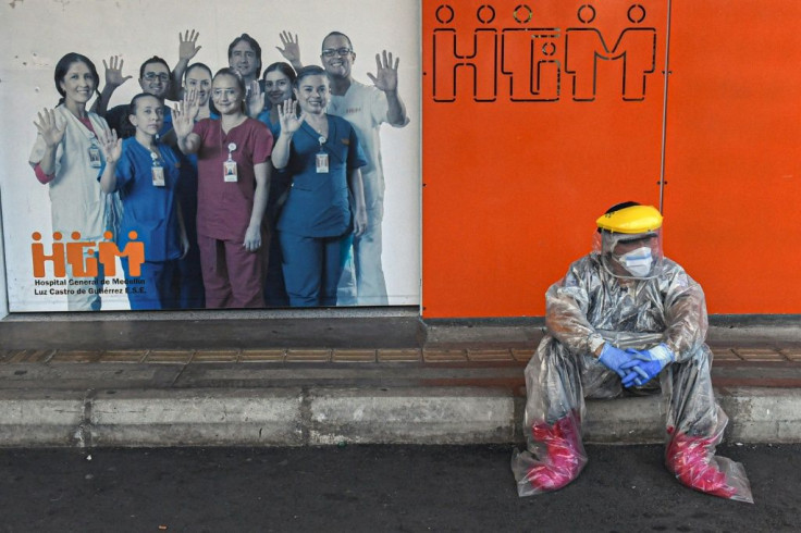 A Colombian health worker takes a break outside Medellin's General Hospital, amid the COVID-19 pandemic