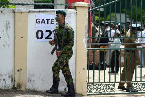A Sri Lanka Special Task Force soldier stands guard as electoral officials collect ballot papers and boxes from a distribution centre in Colombo