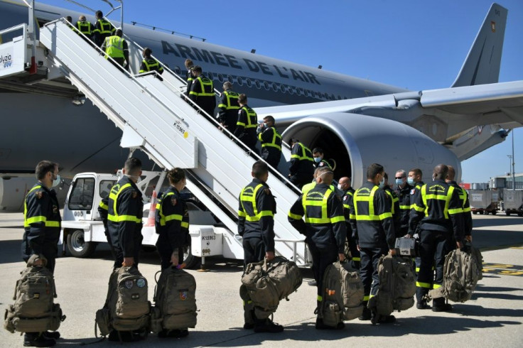 French Securite Civile (Civil Security) personnel board a plane near Paris, as France sends search and rescue experts aboard three military planes loaded with a mobile clinic and medical equipment to Beirut, a day after a powerful explosion there