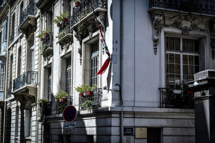 The Lebanese national flag flies at half-mast at the Lebanon embassy in Paris after a powerful explosion tore through the capital city Beirut