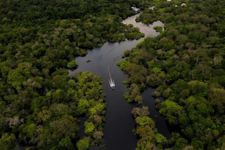 Aerial view showing a boat speeding on the Jurura river in the municipality of Carauari, in the heart of the Brazilian Amazon Forest, on March 15, 2020