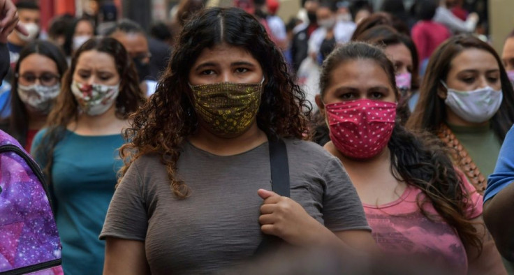 People walk along a commercial street, in downtown Sao Paulo, Brazil on August 4, 2020, amid the new coronavirus pandemic