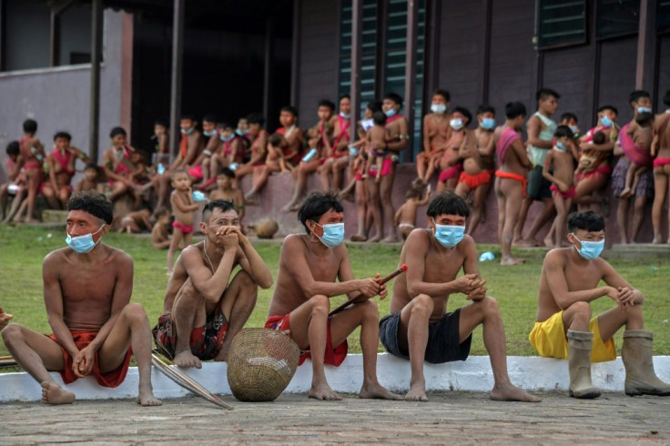 Members of the Yanomami ethnic group wear face masks as they await tests for COVID-19 -- some tribe members have lost loved ones and been unable to practice their ancestral funeral rites