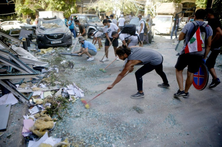 Despairing of receiving any help from the government, volunteers set about clearing the mangled metal and broken glass from their streets