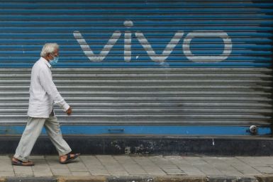 A pedestrian walks past an advert for Chinese mobile phone maker VIVO in Mumbai