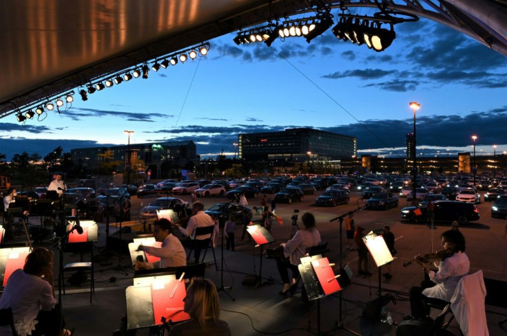 The Montreal Symphony Orchestra performs in a parking lot at Trudeau International Airport on August 5, 2020 during a socially distanced "drive-in" concert