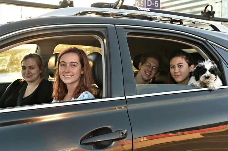 Student Yuni Lavoie (2nd L), 20, along with three friends and a dog, attended the drive-in concert