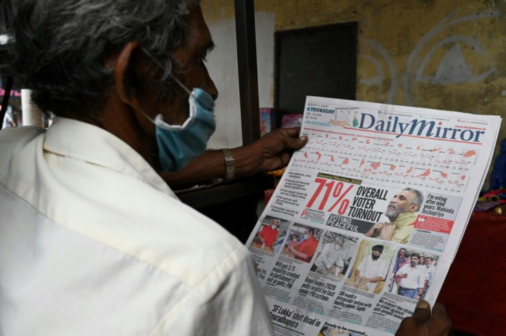 A man reads a newspaper in Colombo a day after Sri Lanka's parliamentary polls saw a turnout of over 70 percent