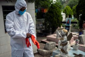 A gravedigger gets ready to work during a funeral at the San Isidro cemetery in Azcapotzalco, in Mexico City on August 6, 2020, amid the COVID-19 coronavirus pandemic.