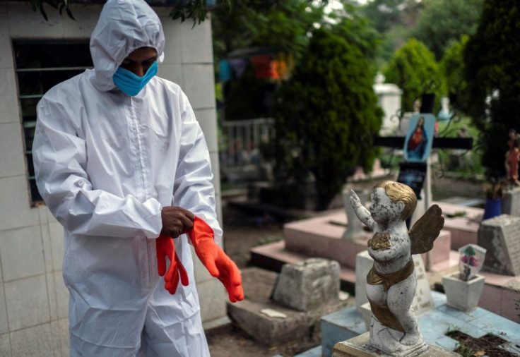 A gravedigger gets ready to work during a funeral at the San Isidro cemetery in Azcapotzalco, in Mexico City on August 6, 2020, amid the COVID-19 coronavirus pandemic.