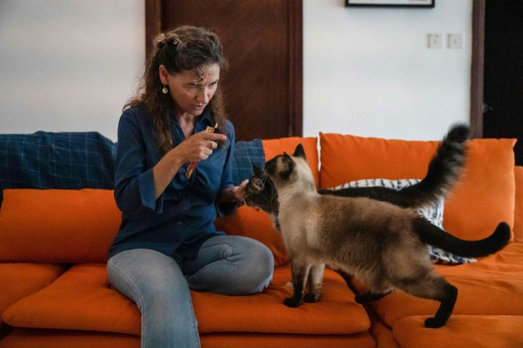 Feline behaviourist Briganne Carter (with her cats Poppet and Prudence,  front), mostly helps cat owners deal with problems like scratched furniture and aggression