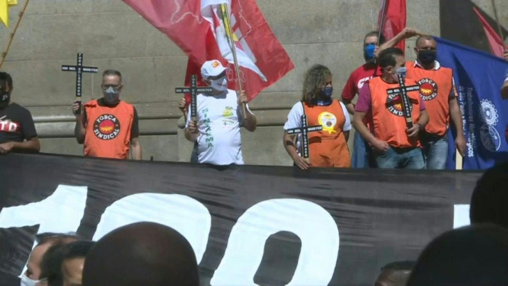 Dozens of members of Brazilian trade unions  protest the way Jair Bolsonaro's government has been handling the coronavirus pandemic, as Brazil's COVID-19 death toll nears 100,000.