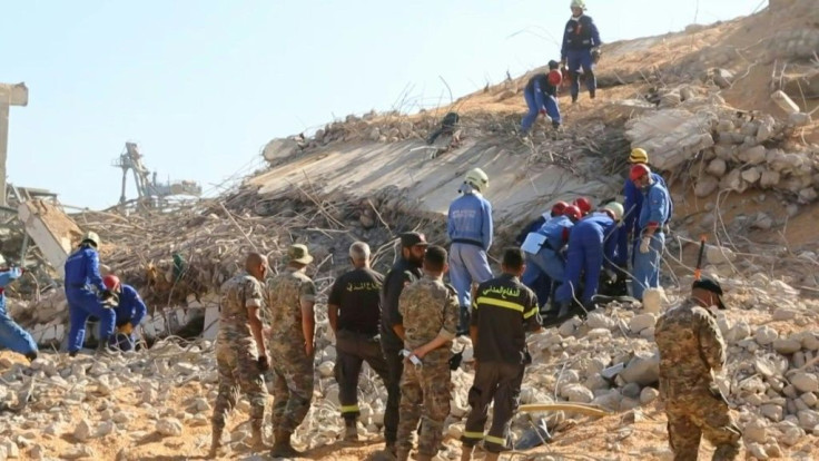 Ankle-deep in corn spilling out of a huge gutted silo, rescuers guide an excavator to clear access to a room where they believe Beirut port employees could still be alive. Three days after the monster explosion that disfigured the city in a few seconds, t