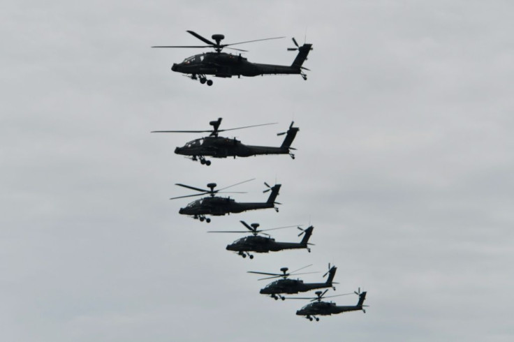 US-made AH-64E Apache attack helicopters fly in formation during the annual military drills in Taichung, Taiwan in July 2020