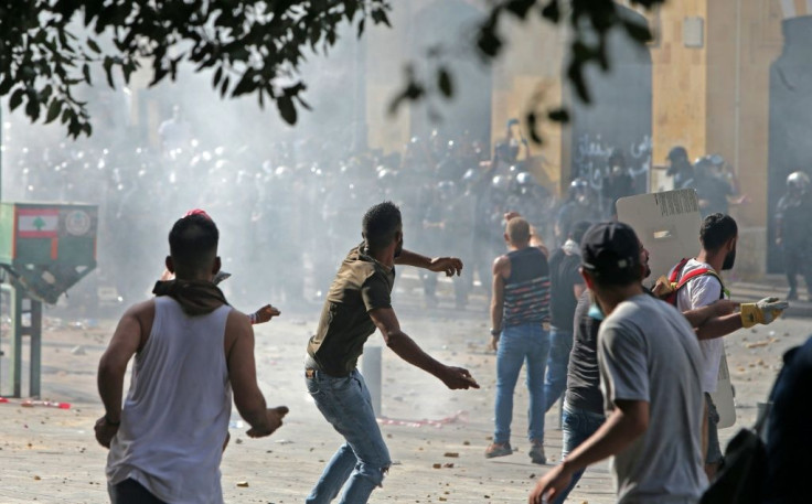 Lebanese protesters hurl rocks towards security forces during clashes in downtown Beirut