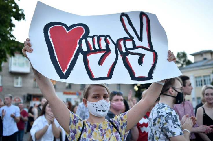 Supporters of Belarusian presidential candidate Svetlana Tikhanovskaya parade through the streets of Minsk on August 6, 2020