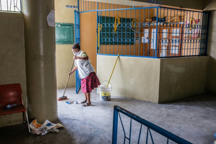 A worker at the Lycee Petion-Ville in Port-au-Prince cleans an office as schools across Haiti prepare to reopen