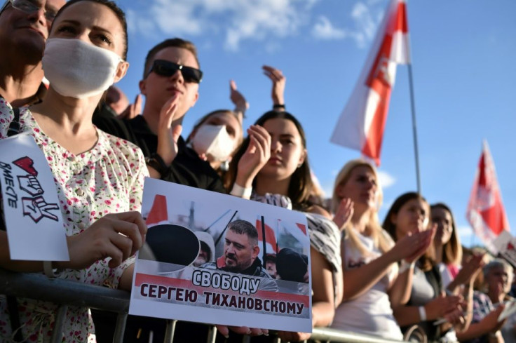 A woman in Minsk holds up a placard reading 'Freedom to Sergei Tikhanovsky' at a campaign rally for the jailed blogger's wife, presidential candidate Svetlana Tikhanovskaya, last month