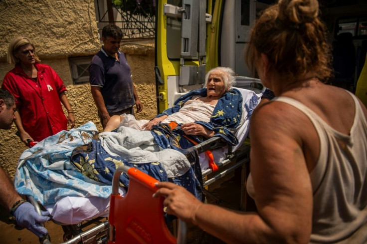 A 98-year-old woman is rescued from the storm's aftermath in Greece's Politka