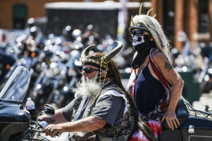 Two cyclists ride down the Main Street in Sturgis, South Dakota, on August 7, 2020 as part of the huge motorcycle rally there