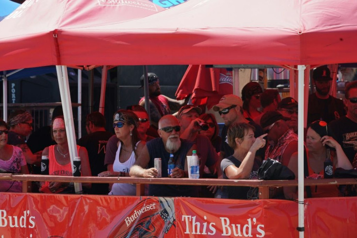 People attending the huge motorcycle rally in Sturgis, South Dakota, gather for drinks under a tent, with no effort at social distancing