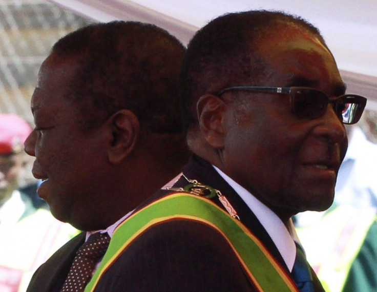 Zimbabwean President Robert Mugabe and Prime Minister Morgan Tsvangirai arrive at a rally marking Zimbabwe&#039;s 31st independence anniversary celebrations in Harare