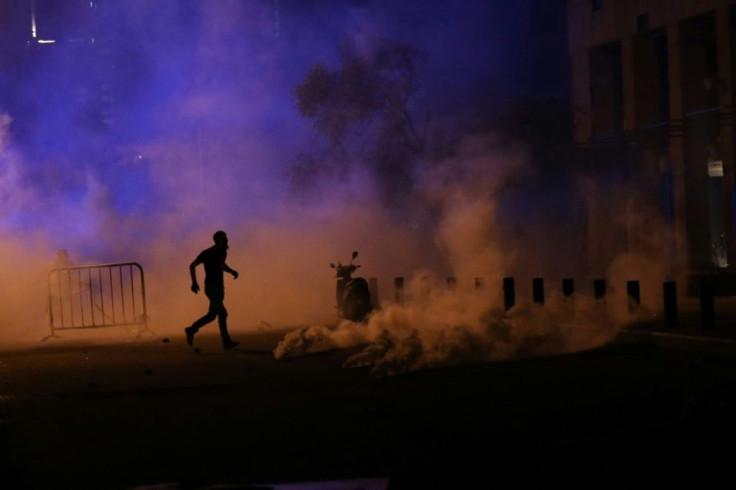Demonstrators lamented that, as the protests turned violent again Sunday, security forces were using tear gas against blast victims instead of helping them clean their wrecked homes