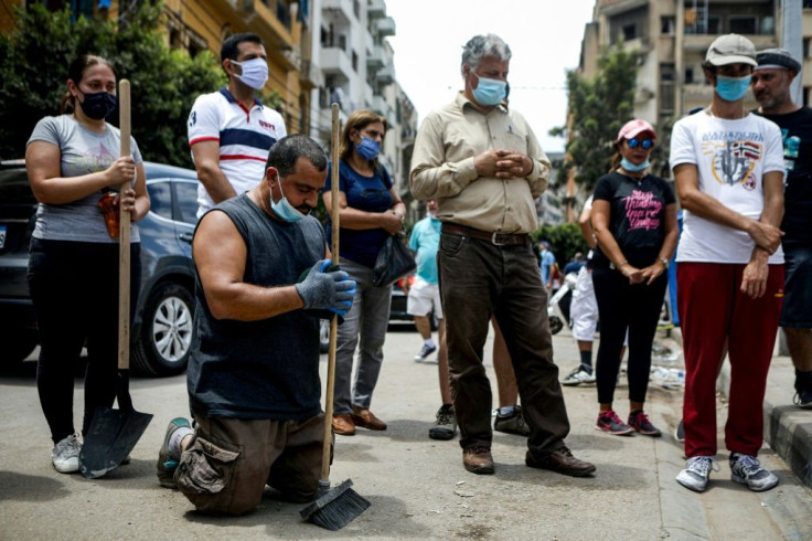 Volunteers and civil society members, mask-clad due to the COVID-19 pandemic, attend an outdoor Sunday mass held by a Maronite Christian priest in the Mar Mikhael neighbourhood of Lebanon's capital Beirut